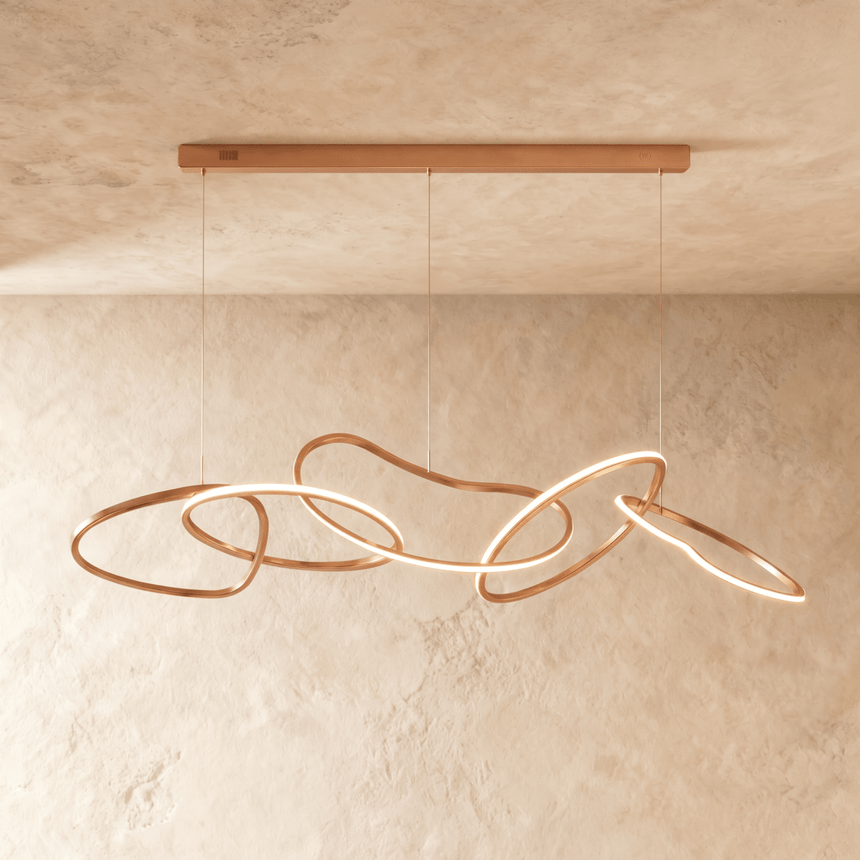 The longest rose gold version, six loops lit along a slim ceiling bar