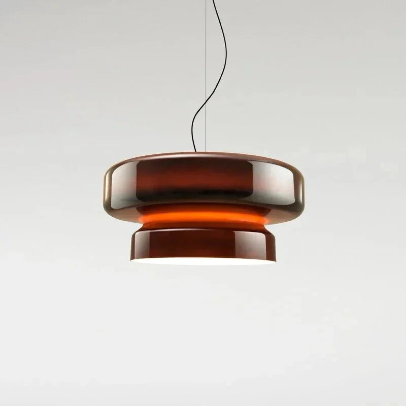 Amber tinted glass shade lit on a plain background