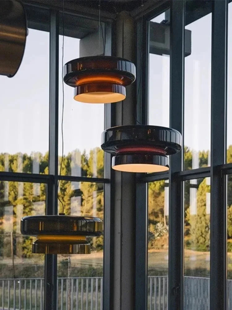 Tinted glass shades hung in a space with glass walls