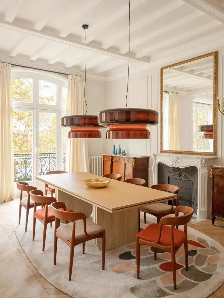 Tinted glass shade above a table beside a window