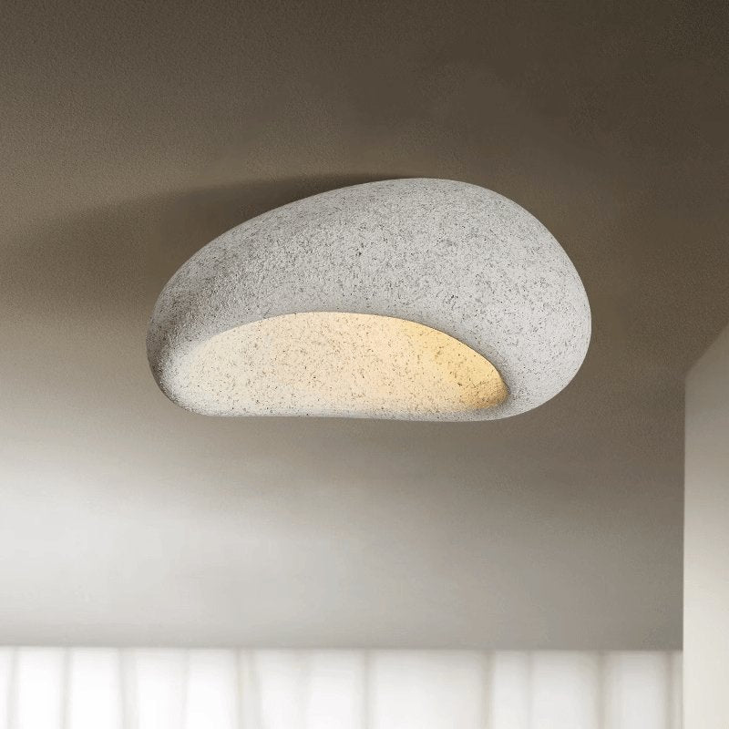 Light gray stone spot dome ceiling light against a plain background