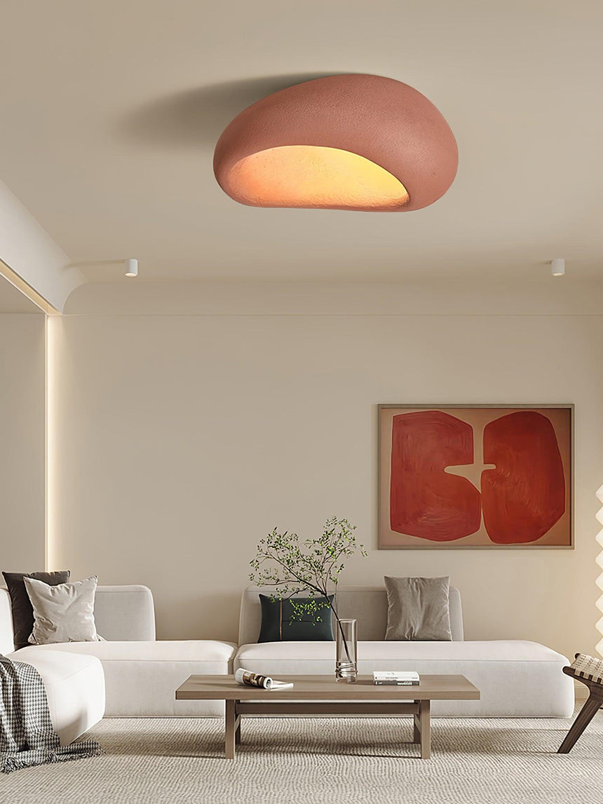 Brick red dome ceiling light in a living room with a red framed artwork