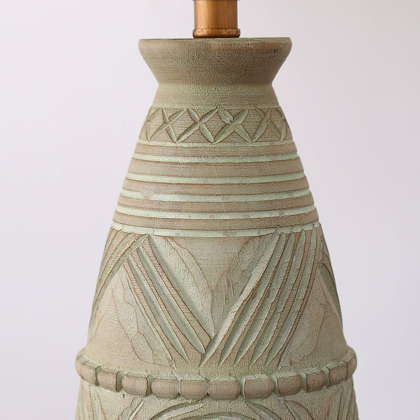 Close view of the carved neck of the base below the socket and shade