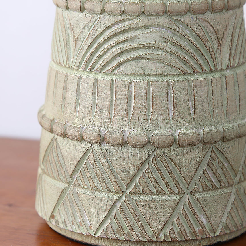 Close view of the carved bands and crosshatching on the pale patina base