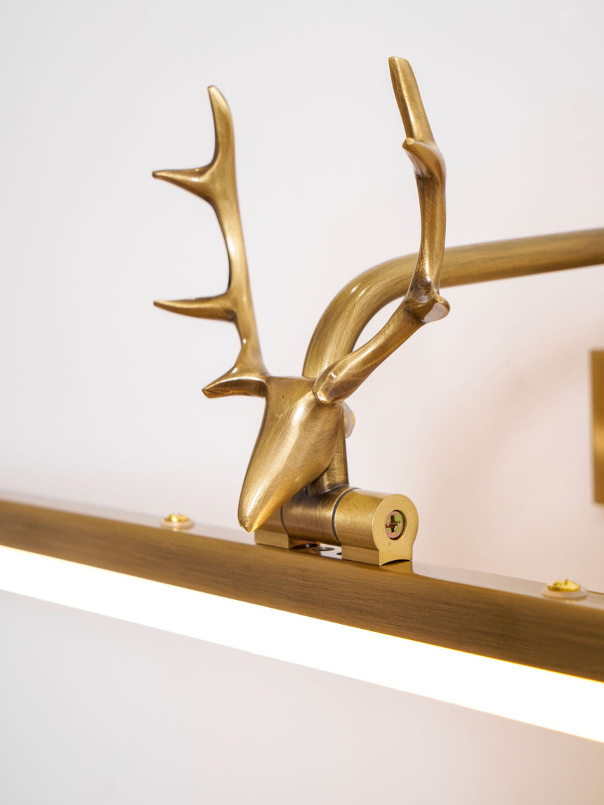 Close view of the antler head in profile, its points curving back over the bar