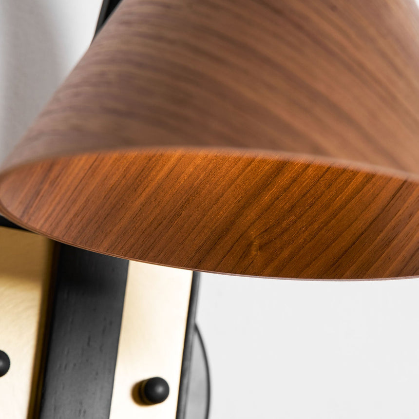 Close view of the turned wood cone shade and the socket inside it