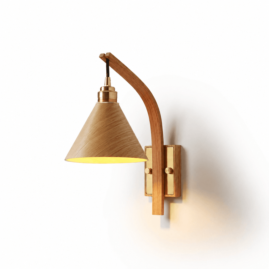 Light wood cone shade lit on a curved wood arm against a plain wall
