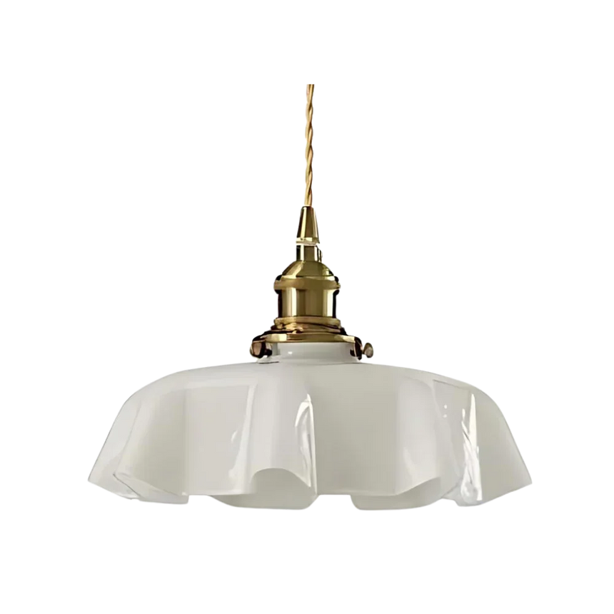 White scalloped glass shade with a brass top on a plain white background