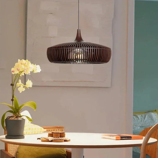 Walnut slatted shade lit above a round dining table