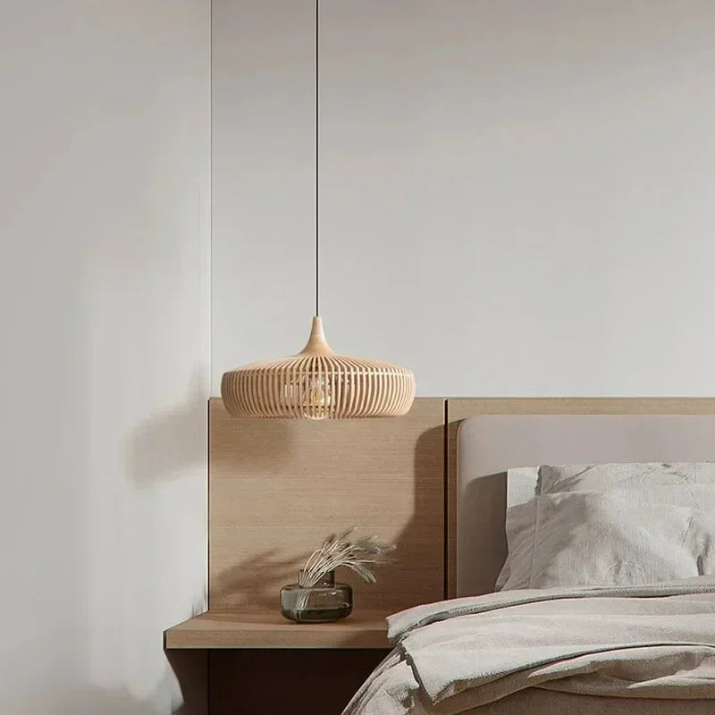 Natural wood slatted shade hung in a bedroom