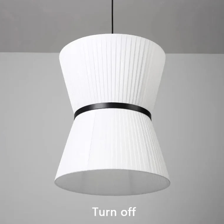Knitted hourglass shade hung beside a tall window