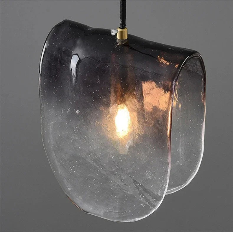 The folded shade lit from within showing the texture of the glass