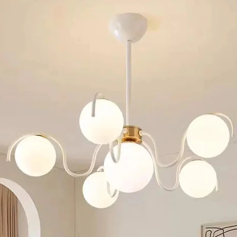 The cream version lit on a white ceiling in a bright pale room