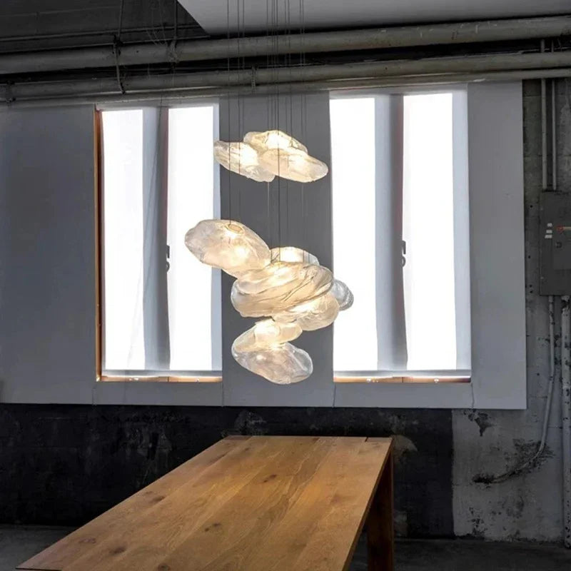 Shells hung in front of a bright window above a long wooden table
