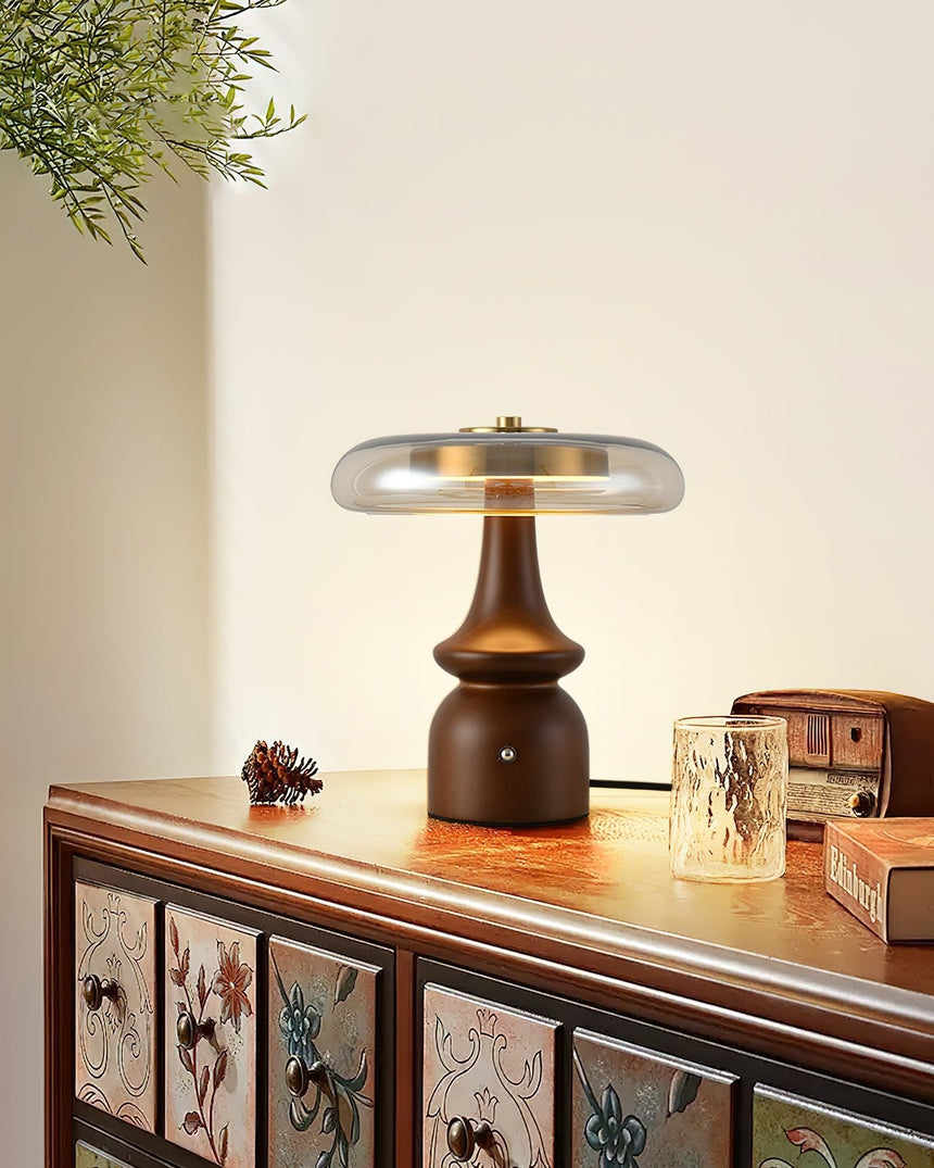 Side table lamp lit on a painted sideboard beside a small box