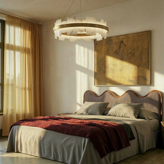 A lit stone ring in a bedroom above a bed with a curved headboard
