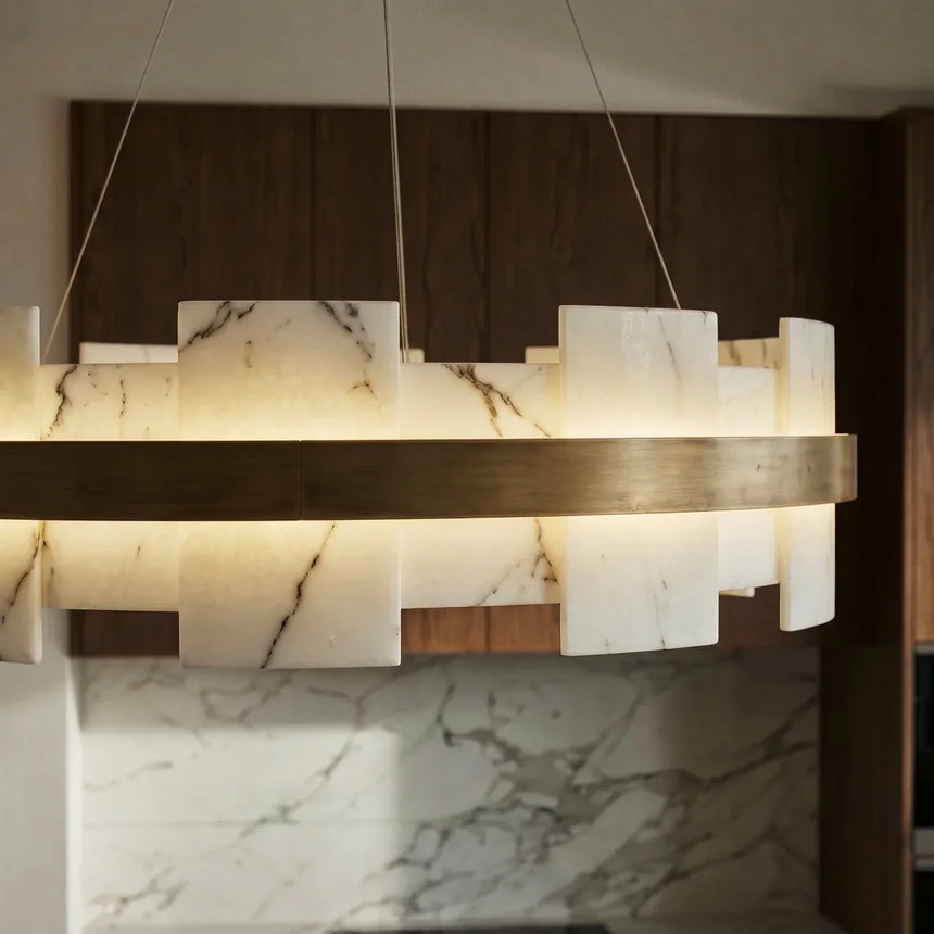A lit stone ring above a marble counter in a timber kitchen