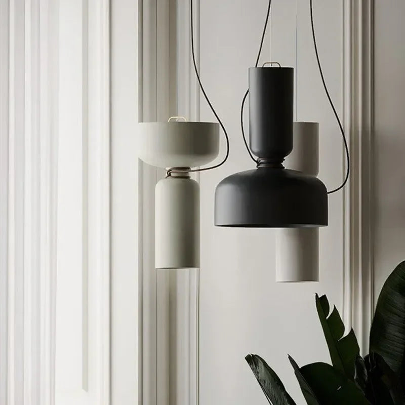 Black and white stacked iron pendant lamps hung side by side