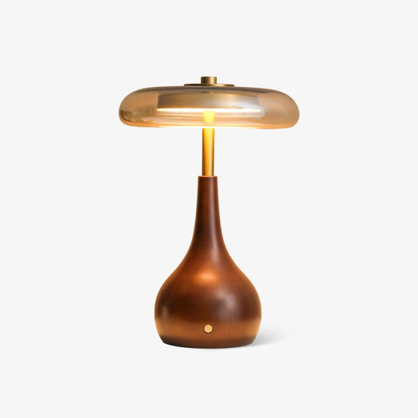 The taller small table lamp seen against a plain pale ground