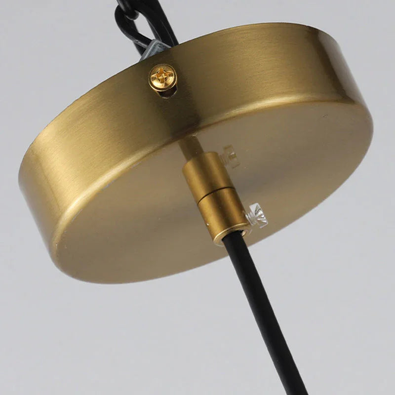 Close view of the brushed brass cap on top of the glass cylinder