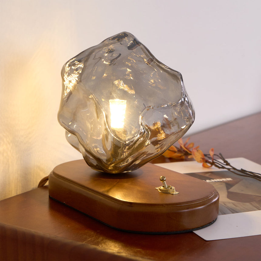 Smoke gray glass ice form lit close, the facets catching light