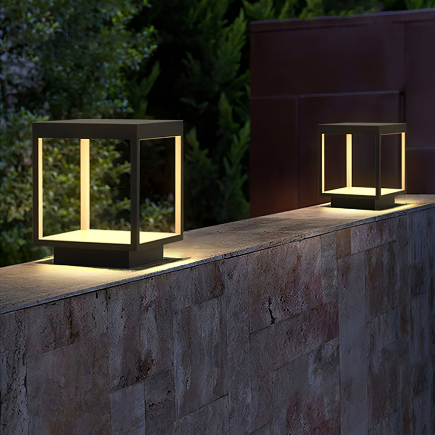 The frame glowing on a stone garden wall with a dark hedge behind