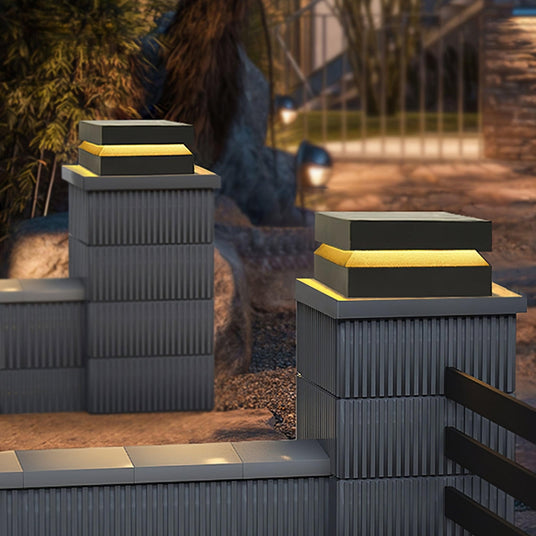 Lit slab caps on stone pillars flanking a flight of garden steps