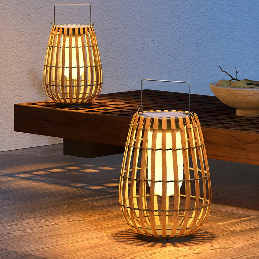 Two lanterns lit on a timber bench on a terrace at the end of the day