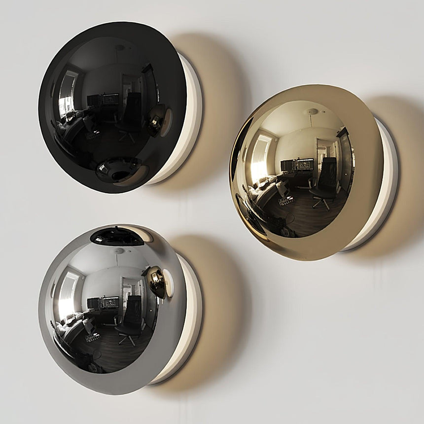 The three finishes, black, gold and chrome, side by side on a wall