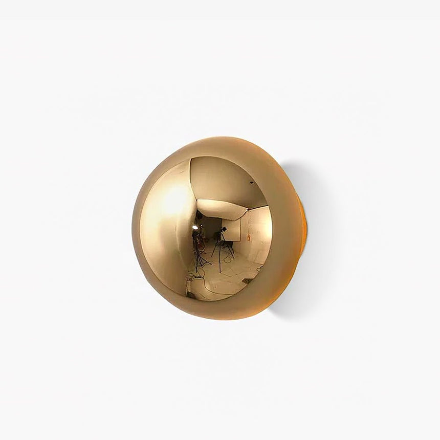 Glossy gold half sphere wall light with a soft LED glow around its rim