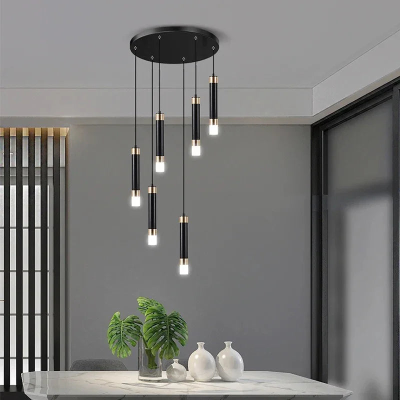 The cluster hung short above a dining table with vases on a sideboard behind
