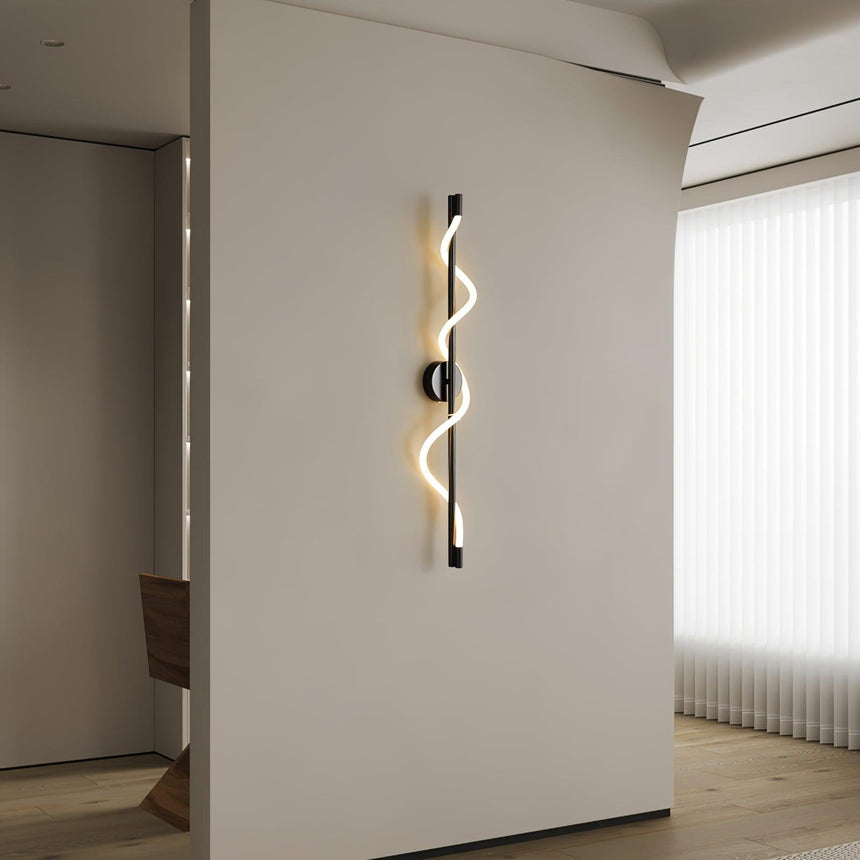 The lit spiral on a white wall in a hallway beside an open doorway