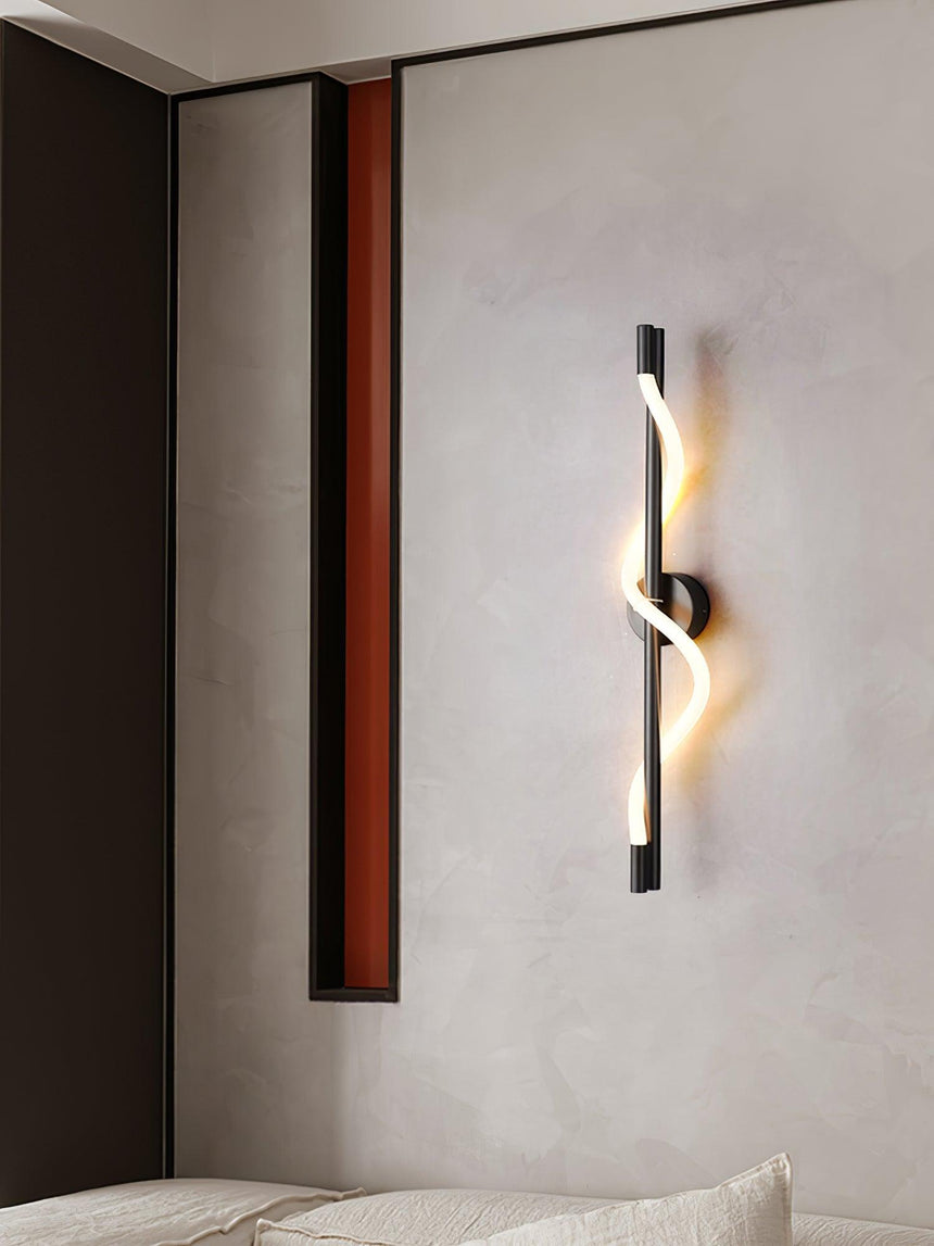 The lit spiral on a plaster wall above a low sofa and a side table