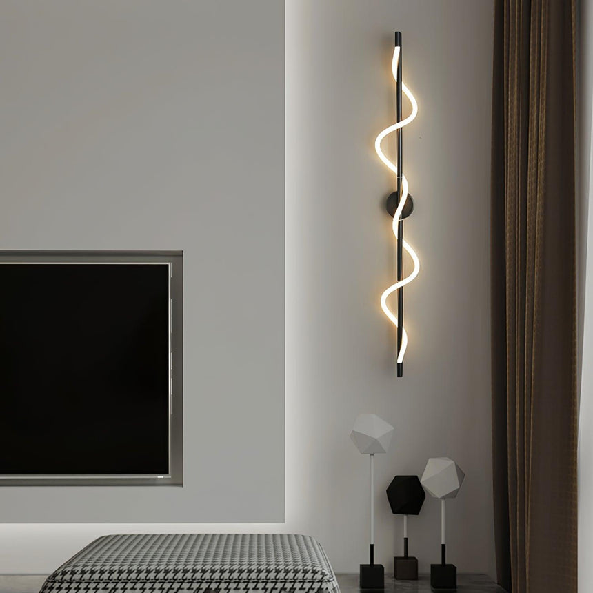 The lit spiral beside a screen above a bench in a bedroom
