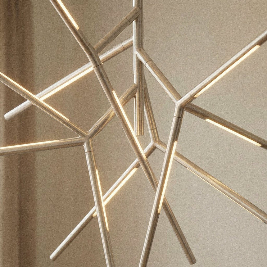 The chrome arms lit against a pale wall, showing how the rods meet at the hub