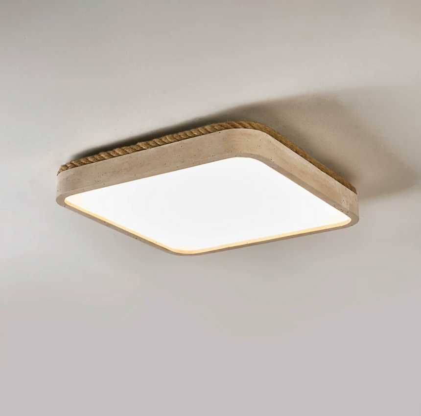 Square travertine ceiling light lit and seen from below at an angle