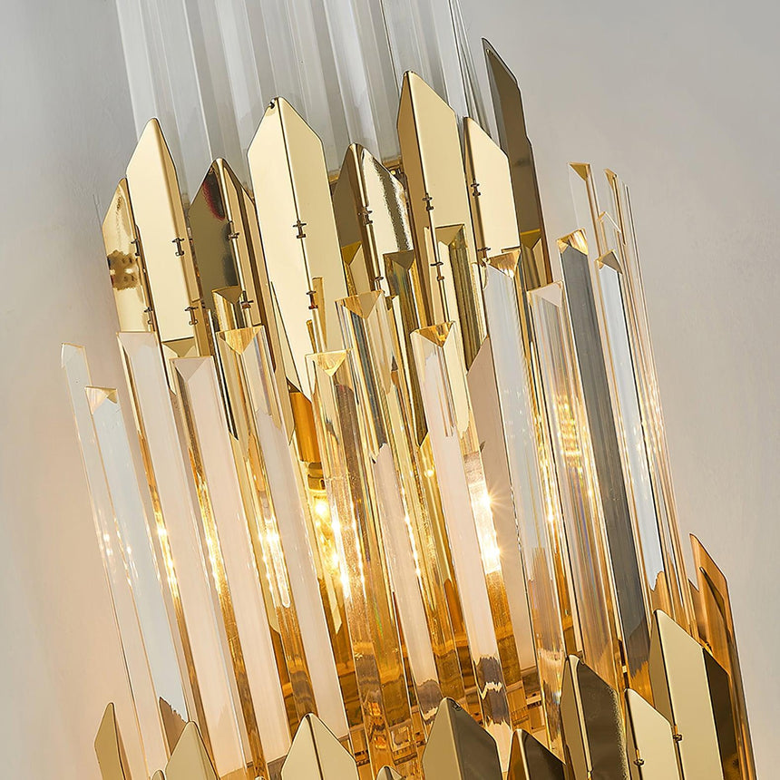 Close view of the polished gold blades and the long crystal prisms, lit