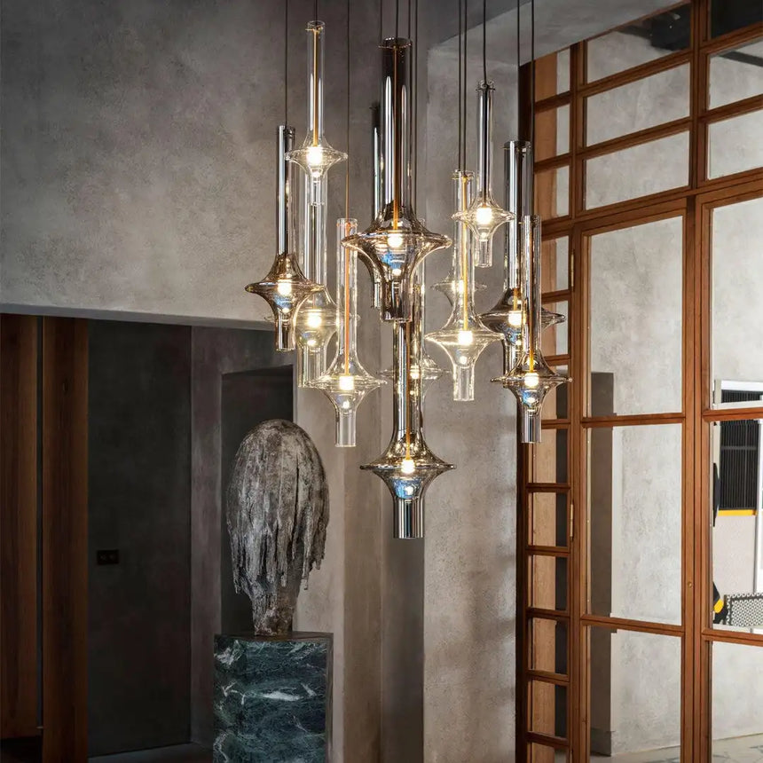 Several spindles lit in a room with a wooden screen and a stone wall