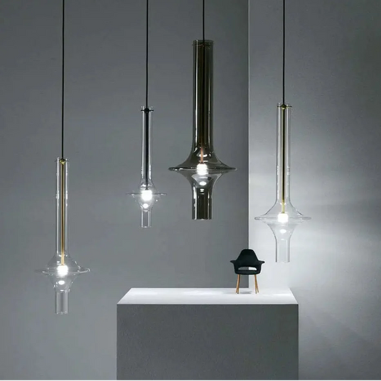 Three spindles hung at staggered heights in a dark lounge beside a low console