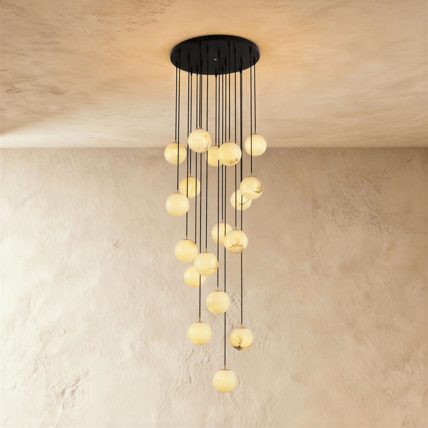 Eighteen lit alabaster spheres in the longest cascade, on a black plate