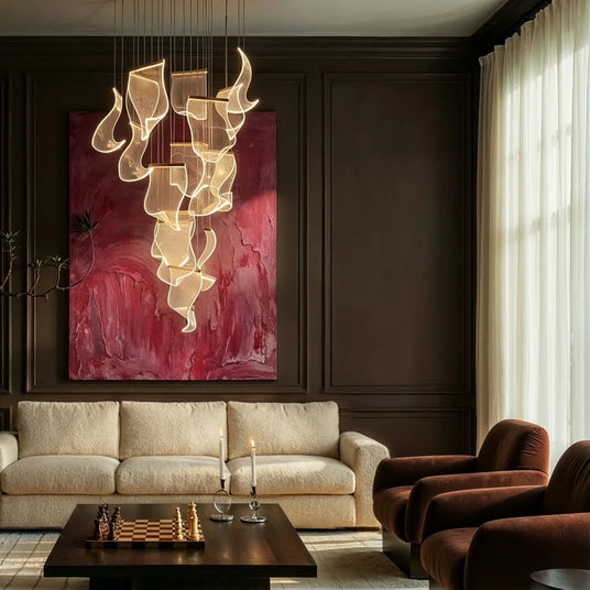The cascade above a living room sofa and armchair beside a large red painting