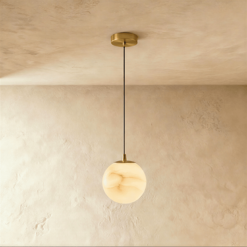 One lit alabaster sphere on a cord below a small brass ceiling plate