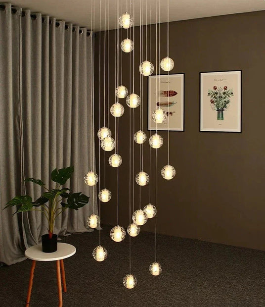 Spheres falling in a living room corner beside framed prints and a chair