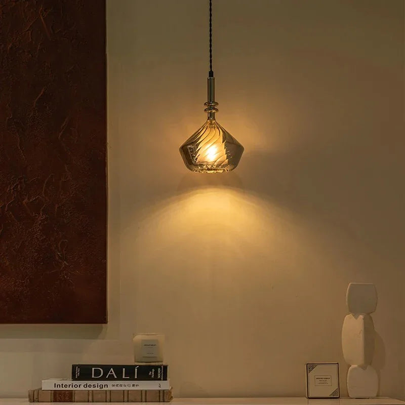 The amber shade lit in a dark corner above a table with a book