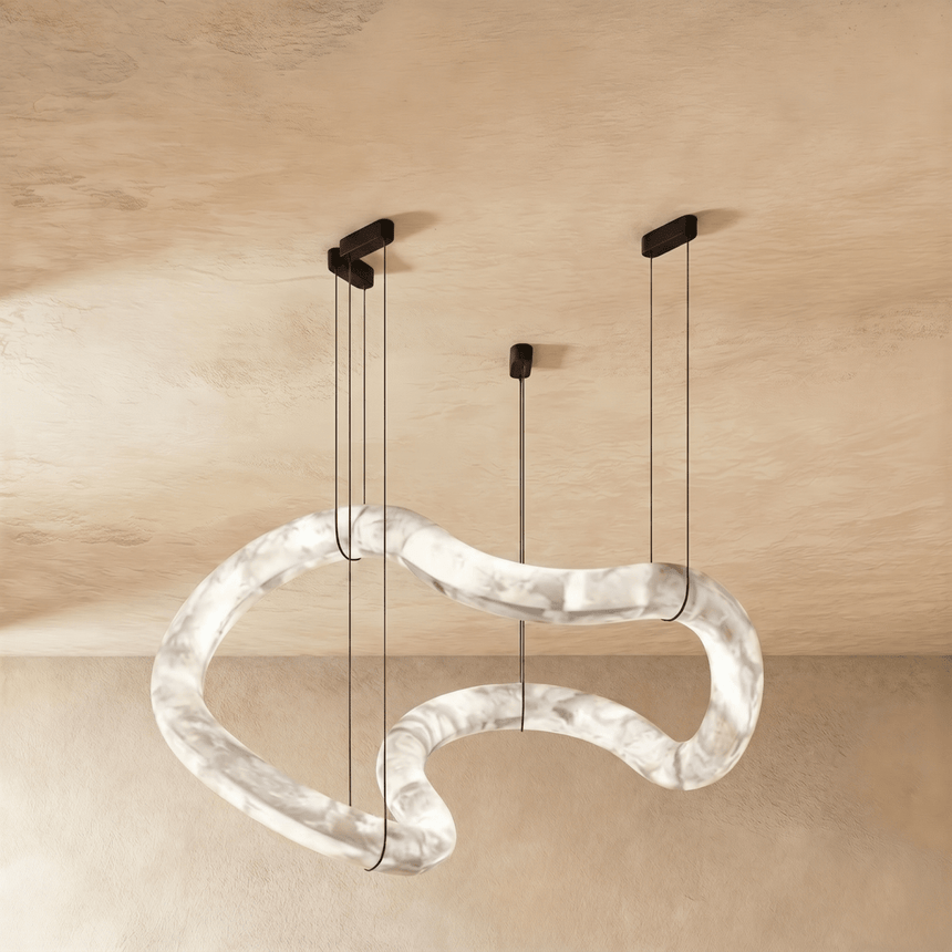 One winding alabaster tube lit, hung on four cables from a plaster ceiling