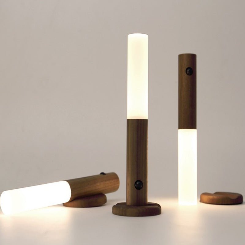 Three tubes standing on round wood bases, one lying down beside them
