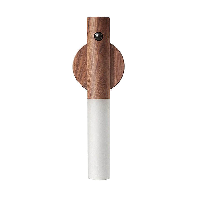 The walnut collar and white tube seen against a plain pale background