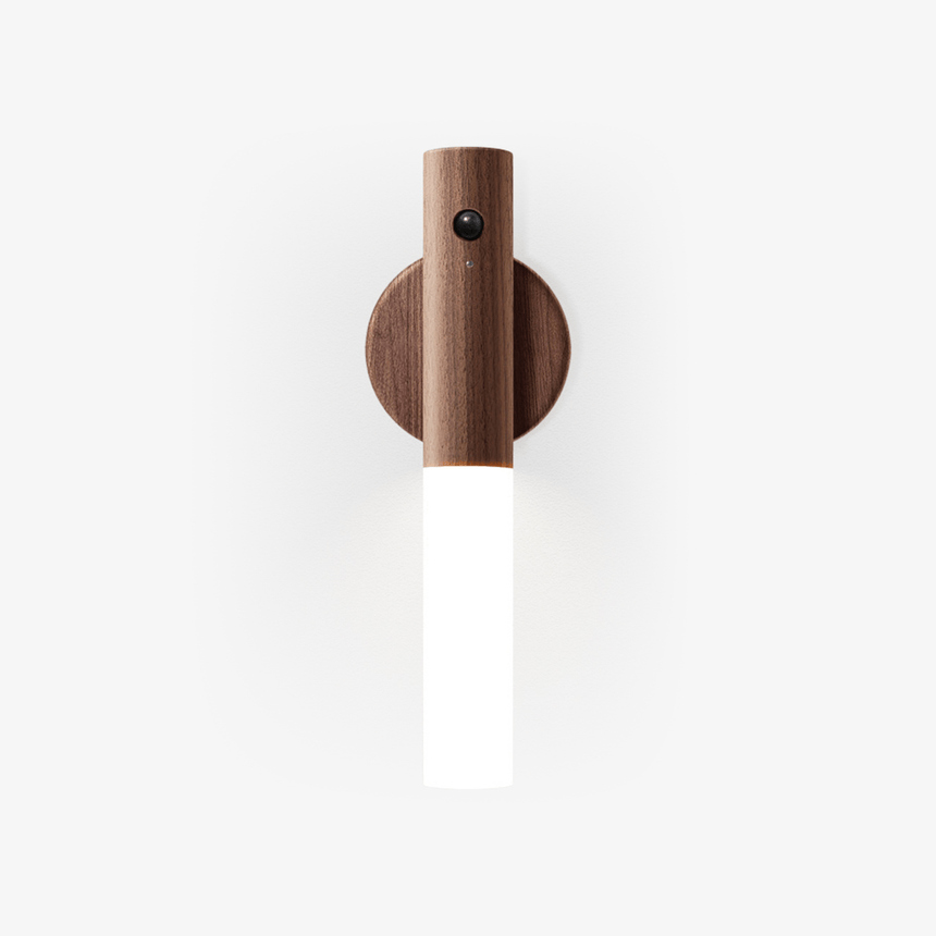A frosted tube on a walnut collar held to a round magnetic wall plate