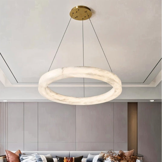 The lit stone ring above a living room with a sofa and a low table