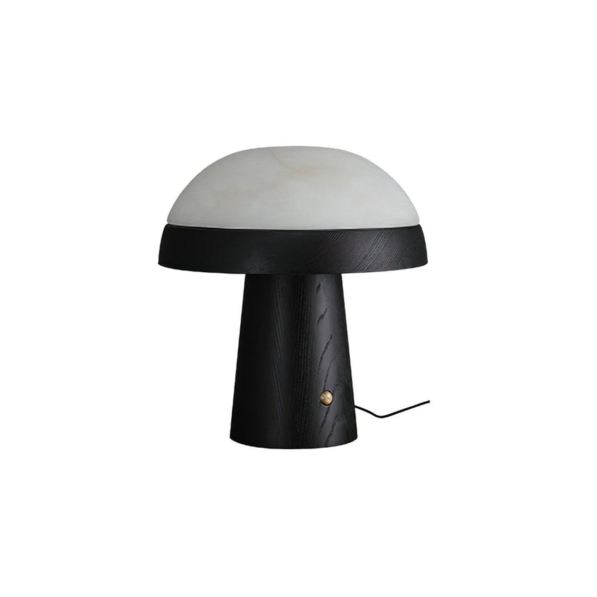 Stone table lamp with a black base against a plain ground